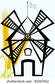 An old mill on a background of ripe wheat ears