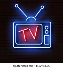 Old Neon TV With Antenna On Brick Wall Lights Up At Night