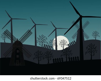 old and new windmill in idyllic landscape at night