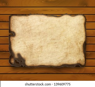 Old  paper with burnt edges isolated on a wooden background. Vector  eps10
