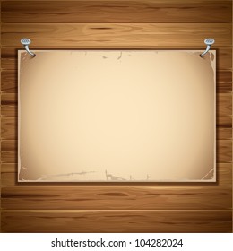 Old paper sheet nailed to a wooden background