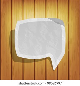 Old paper talk cloud on the wooden background