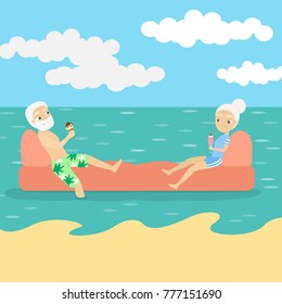 Old people relaxing on the beach and swimming in the sea.