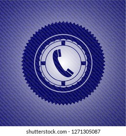 old phone icon inside badge with jean texture