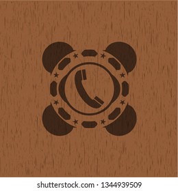 old phone icon inside badge with wooden background