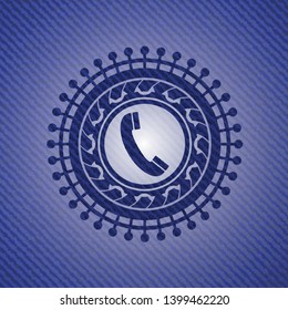 old phone icon inside badge with denim texture