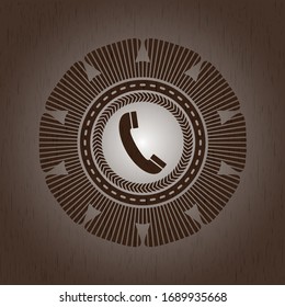 old phone icon inside badge with wooden background