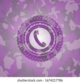 old phone icon inside pink camouflaged emblem