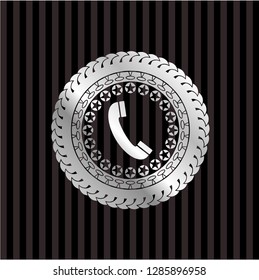 old phone icon inside silver emblem or badge