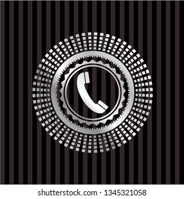 old phone icon inside silver emblem