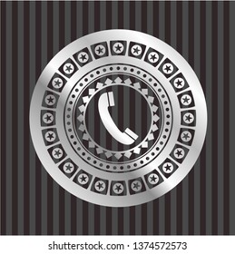 old phone icon inside silver emblem