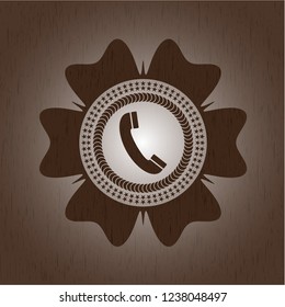 old phone icon inside vintage wooden emblem