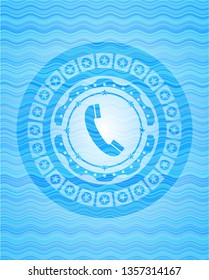 old phone icon inside water wave representation emblem background.