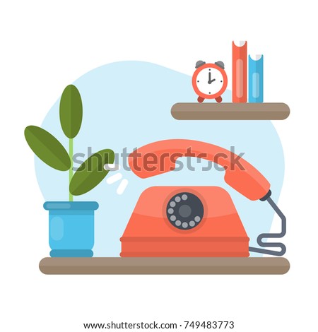 Old phone ringing. Red old-fashioned device standing on the shelf at home.