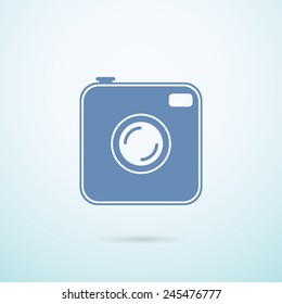 Old photo camera flat icon on blue background.