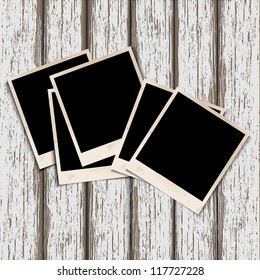Old photo frames on old wooden background. Vector illustration