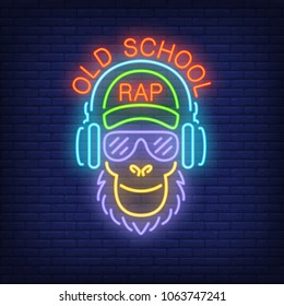 Old school rap neon text and cool monkey in glasses and headphones. Neon sign, night bright advertisement, colorful signboard, light banner. Vector illustration in neon style.