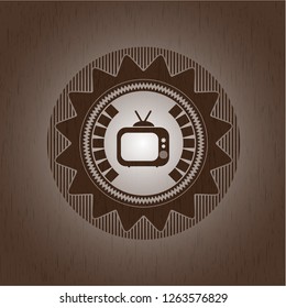 old tv, television icon inside wood emblem