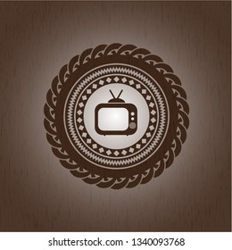 old tv, television icon inside badge with wooden background