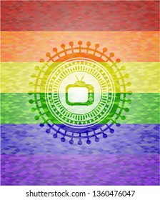 old tv, television icon inside emblem on mosaic background with the colors of the LGBT flag