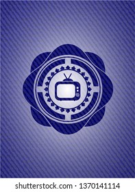 old tv, television icon inside badge with denim background