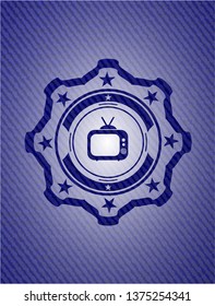 old tv, television icon inside badge with denim texture