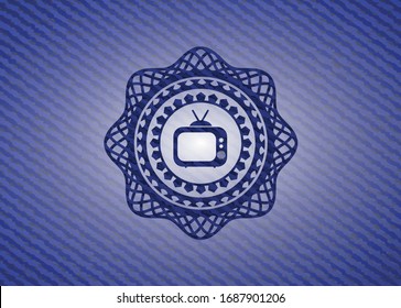 old tv, television icon inside jean or denim emblem or badge background