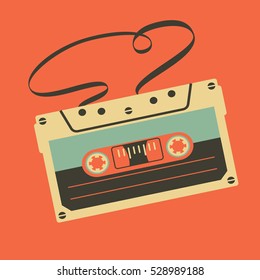 Old vintage audio cassette with tangled tape on orange background 
