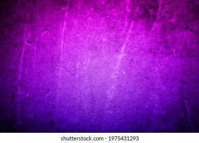 Old violet-lilac wall in spots, cracks, stains. Painted concrete wall in abstract grunge style loft. Vintage wall background texture for backgrounds, portraits, posters.