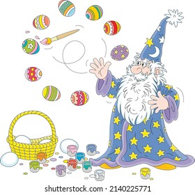 Old wizard with a big white beard coloring and decorating Easter gift eggs with a magic flying paintbrush and bright paints, vector cartoon illustration isolated on a white background