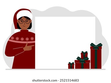 A old woman in a Christmas or New Year's sweater with a red sana cap points his finger at a banner, a blank poster or a large white sheet of paper with space for text.