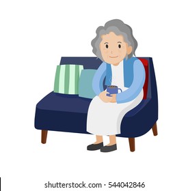 Old woman with a cup of coffee sitting on the sofa.