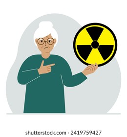 A old woman holds a sign with a warning about nuclear danger. The concept of nuclear war, radiation, biohazard.