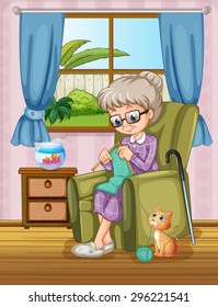 Old woman sitting on a sofa knitting with a cat sitting nearby