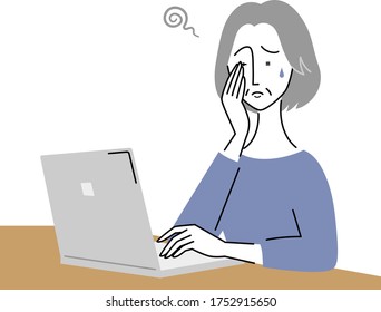 an old woman whose eyes are tired by using a computer