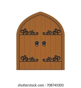 Old wooden massive closed gate. Double door with iron handles and hinges.