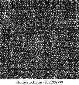 Old wool blanket with a tartan pattern. Worn thick fabric. Grunge textured background. Black and white image.
