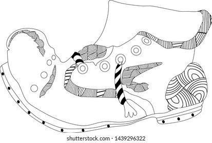 An old, worn shoe with laces covered with an abstract ornament.