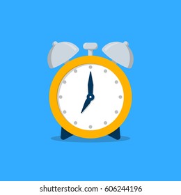 Old yellow alarm clock in flat style isolated on a blue background. Vector illsutration