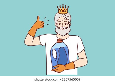 Older man holds bottle of detergent and gives thumbs up, recommending quality liquid fabric softener. Bearded pensioner with golden crown on head advertises new brand of detergent.