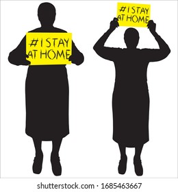 Older woman is holding a sign with the inscription: "I stay at home." For older people. Quarantine grandmother. Exemplar. #"I stay at home" awareness social media campaign and coronavirus prevention.
