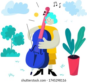 Older woman plays cello as her hobby, surrounded by green nature on a sunny day.