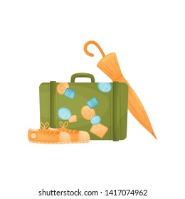 Old-fashioned green suitcase with stickers. Vector illustration on white background.
