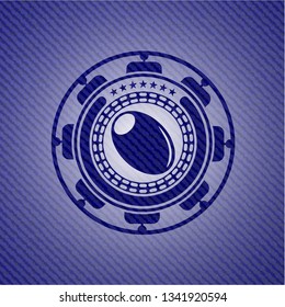 olive icon inside badge with denim background