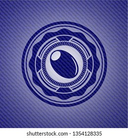olive icon inside badge with denim background
