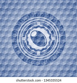 olive icon inside blue emblem or badge with abstract geometric polygonal pattern background.
