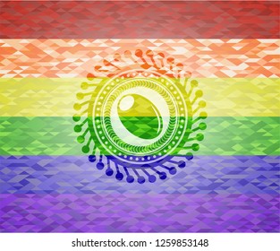 olive icon inside emblem on mosaic background with the colors of the LGBT flag