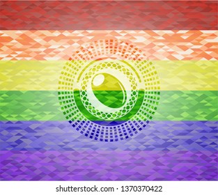 olive icon inside emblem on mosaic background with the colors of the LGBT flag