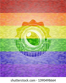 olive icon inside emblem on mosaic background with the colors of the LGBT flag