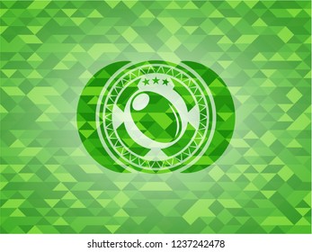 olive icon inside green emblem. Mosaic background